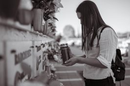 woman holding ashes at grave at direct cremation